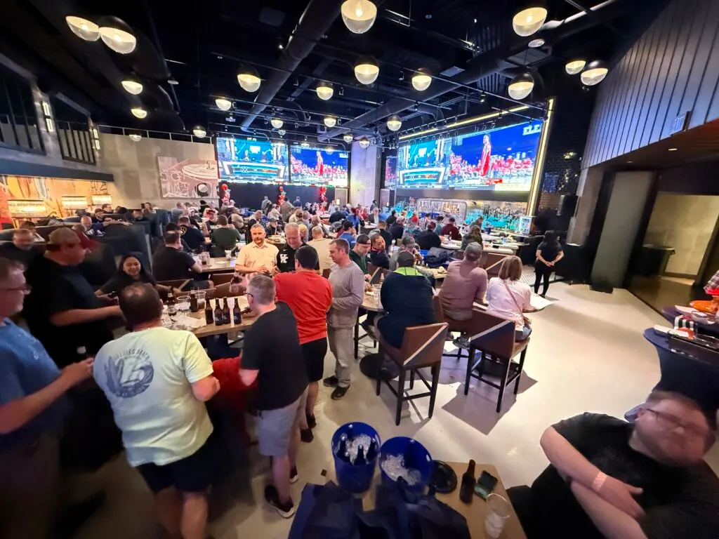 A large crowd in a sports bar watching the March Madness games at STRAT's PT's. 