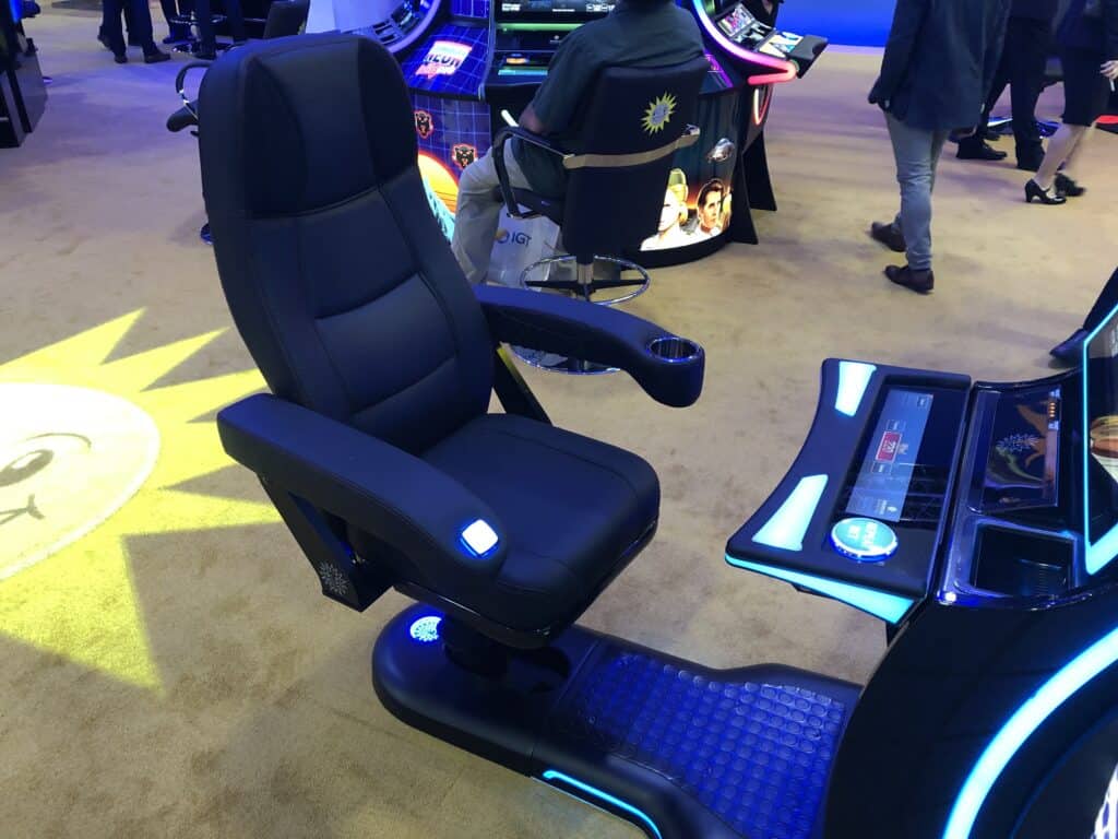 Slot machine chair with drink holder and spin button on arm rests