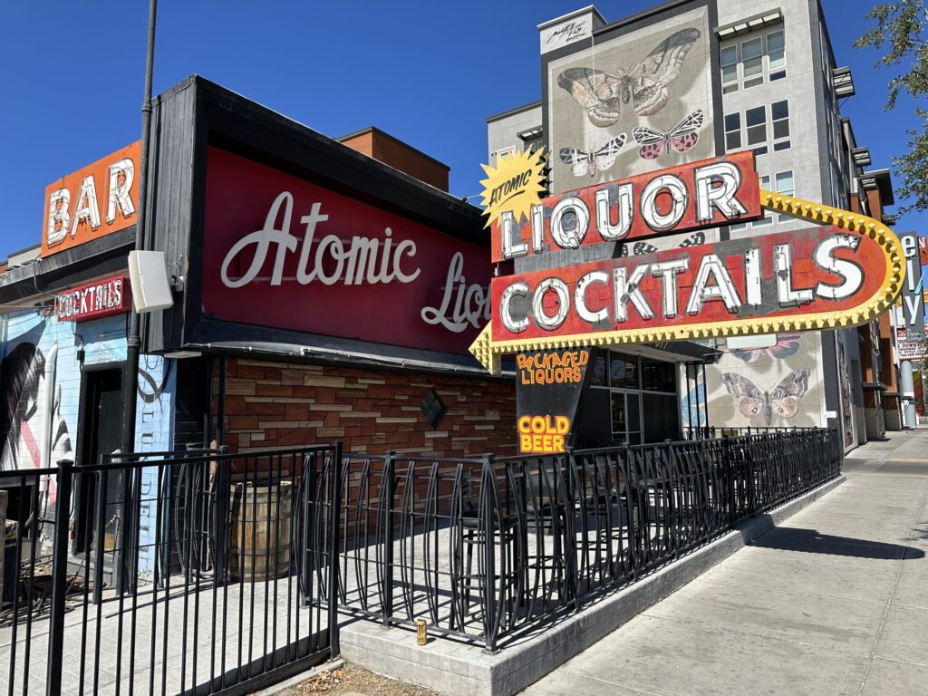 Exterior of Atomic Liquors bar, which includes their iconic neon sign.