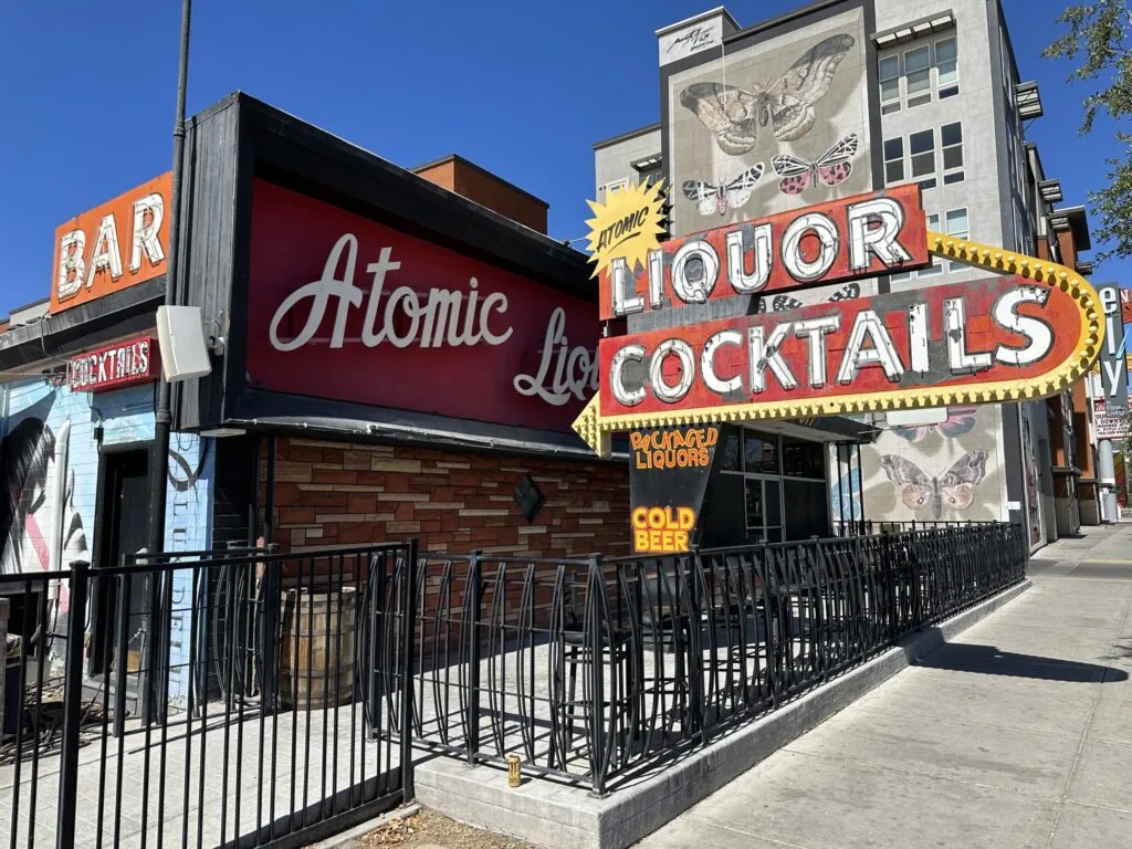 Exterior of Atomic Liquors bar, which includes their iconic neon sign.