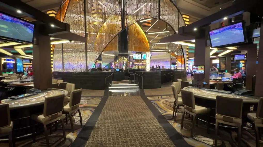 A lounge with illuminated glass as a decorative wall surrounding it. 