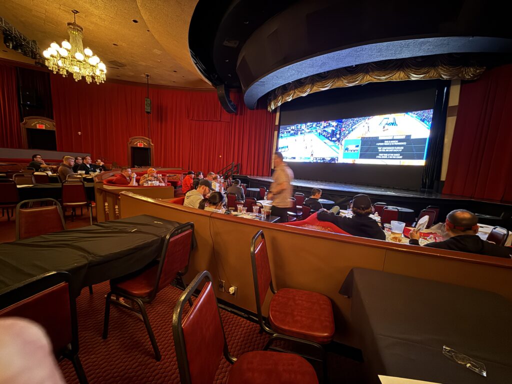 Plaza's theater with basketball projected on the screens.
