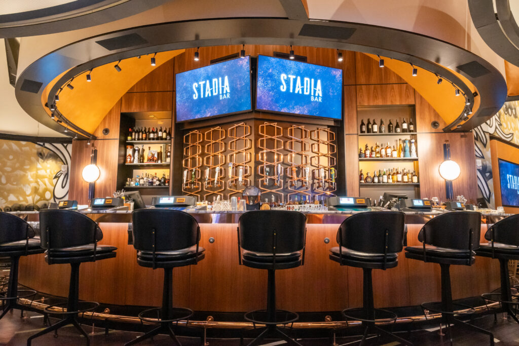 The bar at Stadia with barstool seating and 2 televisions