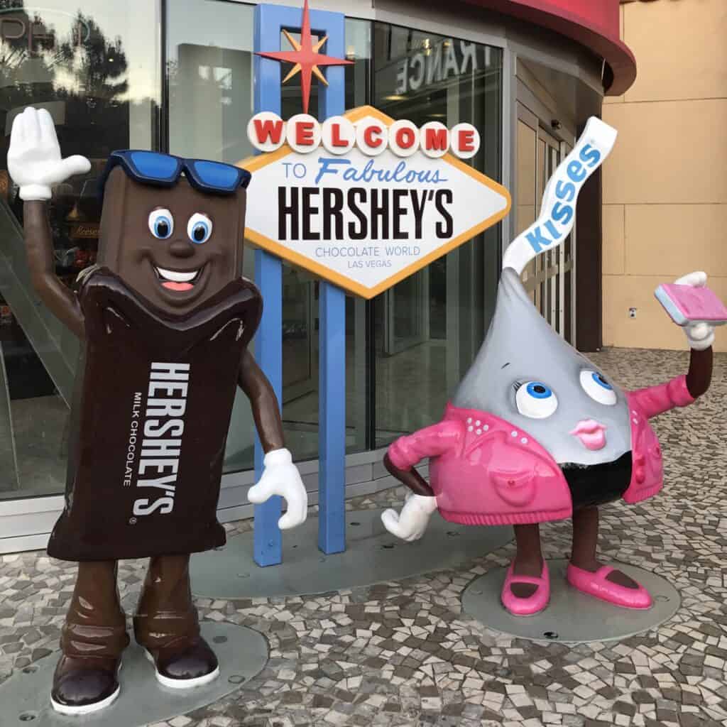 Photo opp depicing a life like Hershey's bar and a Hershey's Kiss in front of a Hershey's sign intended to look like the "welcome to Las Vegas Sign".