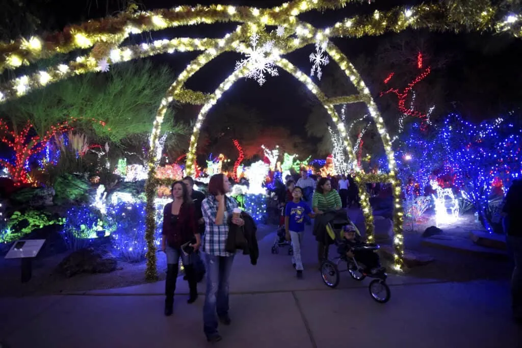 People walking through illuminated decor in The Park