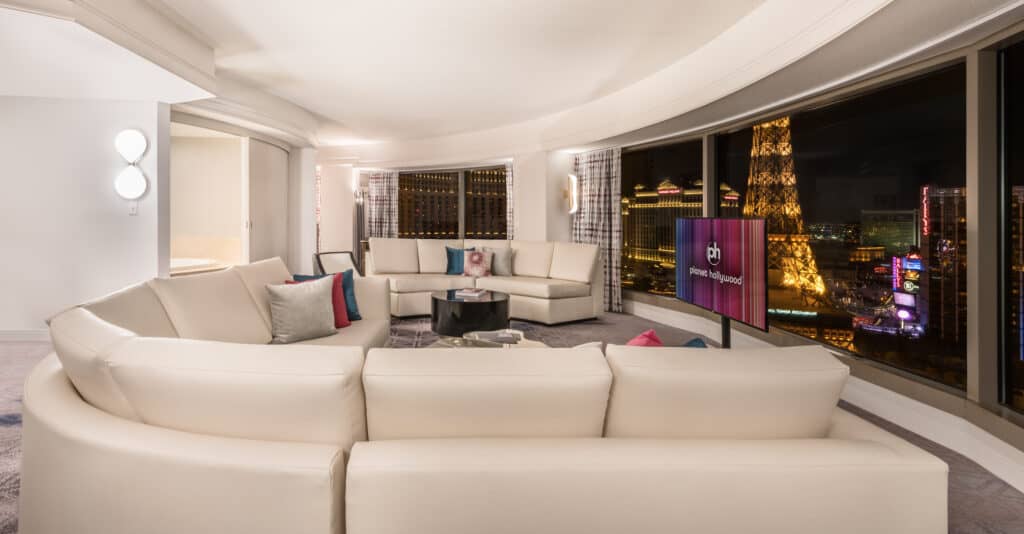 Living area with large sectional couch in Planet Hollywood's Ultra Panorama Suite