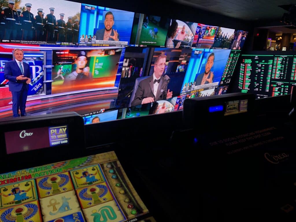 Tabletop gaming at Circa with the sportsbook screen in the background