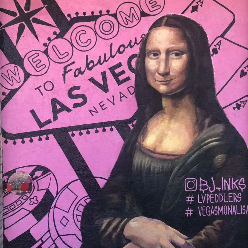 Mona Lisa mural with the Welcome to Las Vegas Sign in the background