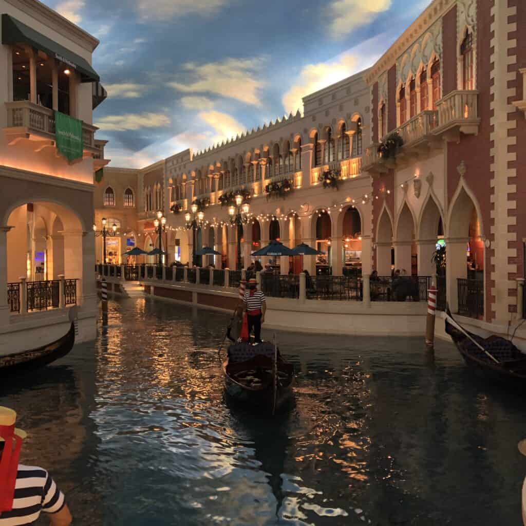 Gondoliers paddle through the canals of the Grand Canal Shoppes