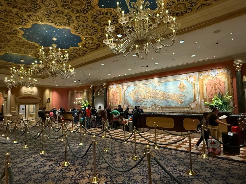 The hotel front desk, with a large mural of a old timey map posted behind it.