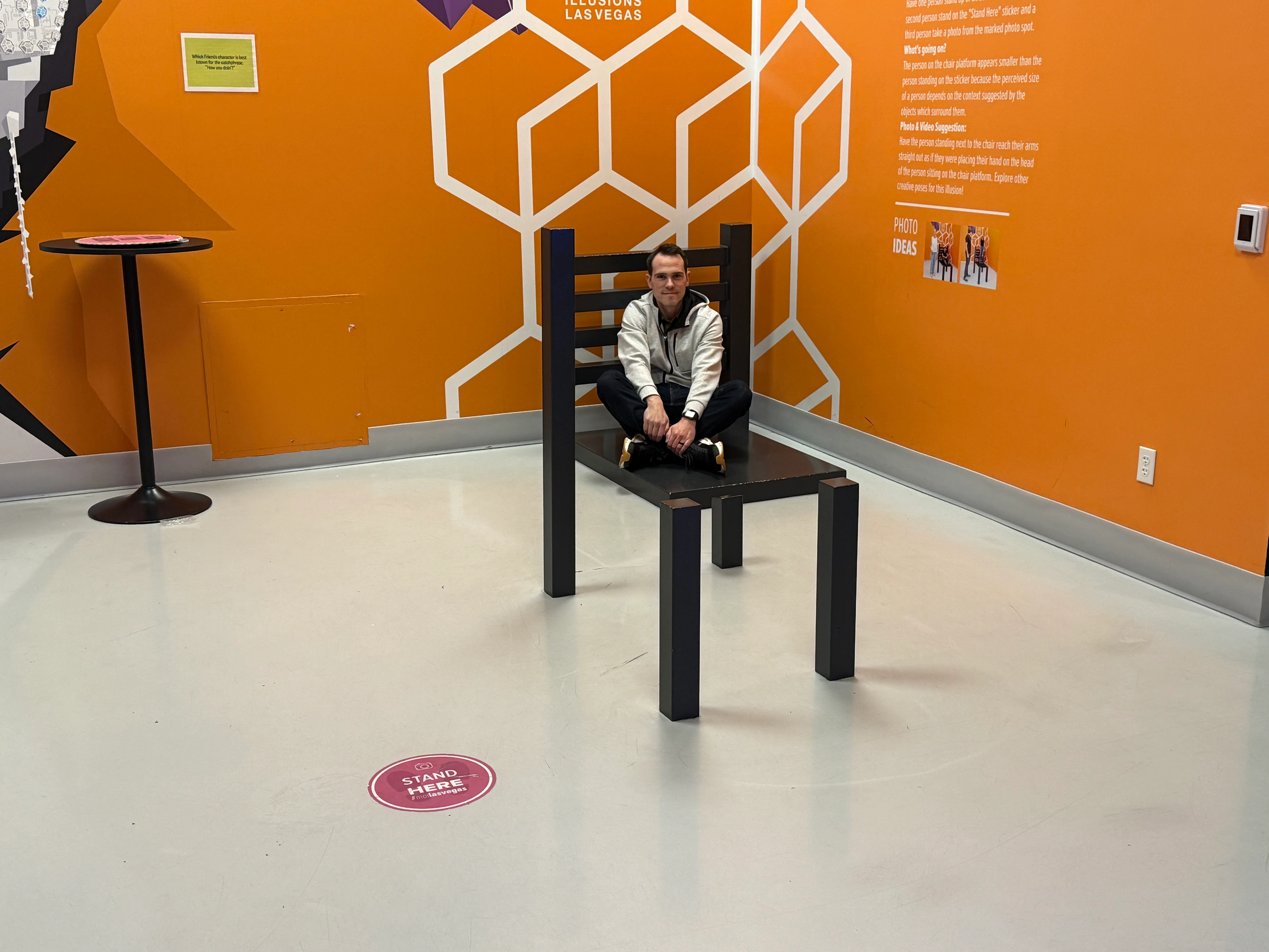 My brother, sitting in on an illusion that makes it appear he is sitting in a chair. 