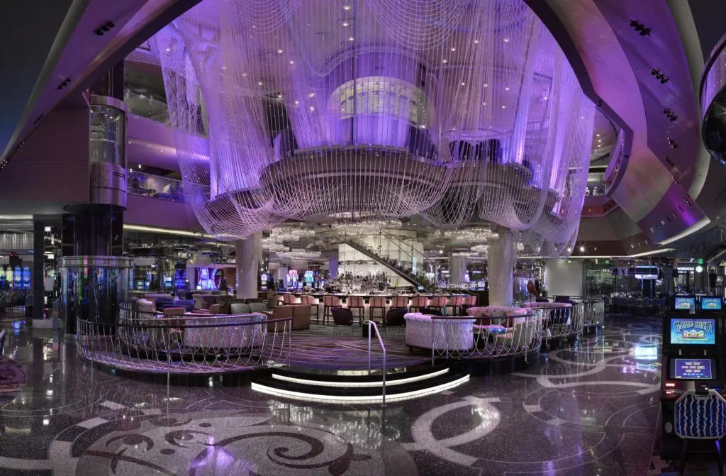 Chandelier Bar at Cosmopoltan, which is bathed in light purple light.