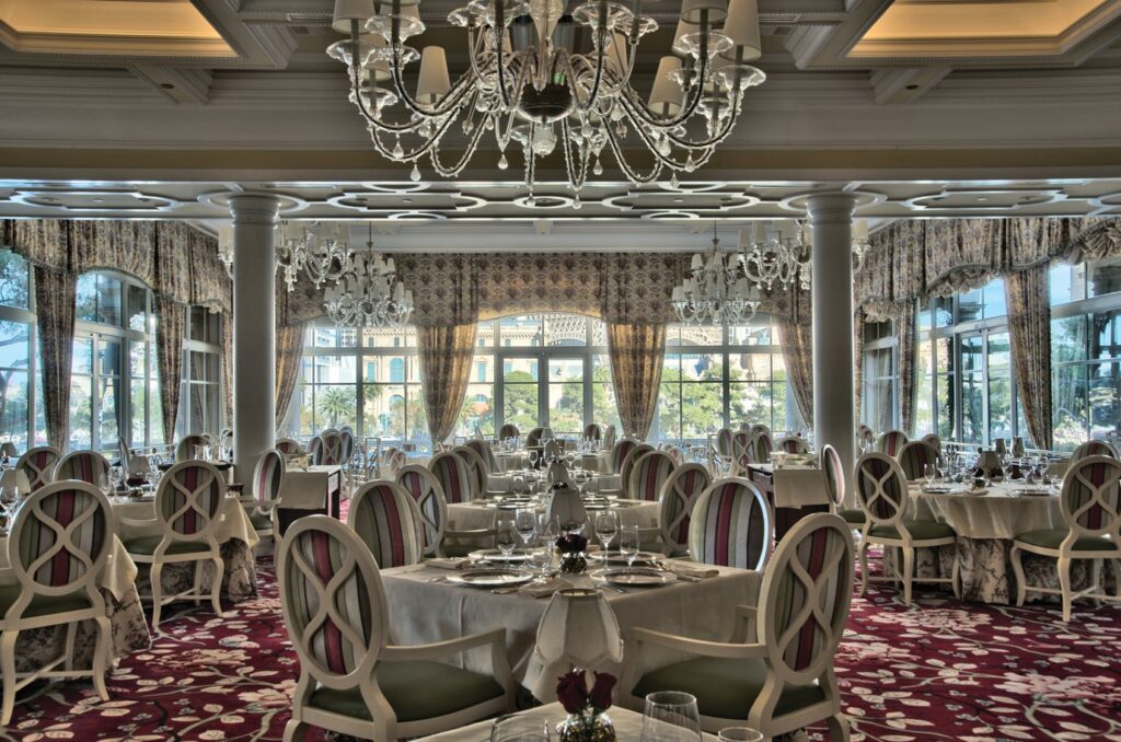 Interior dining at Jasmine with windows in the background. 