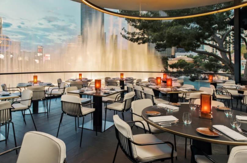 Patio seating at Spago with fountains spraying in the background