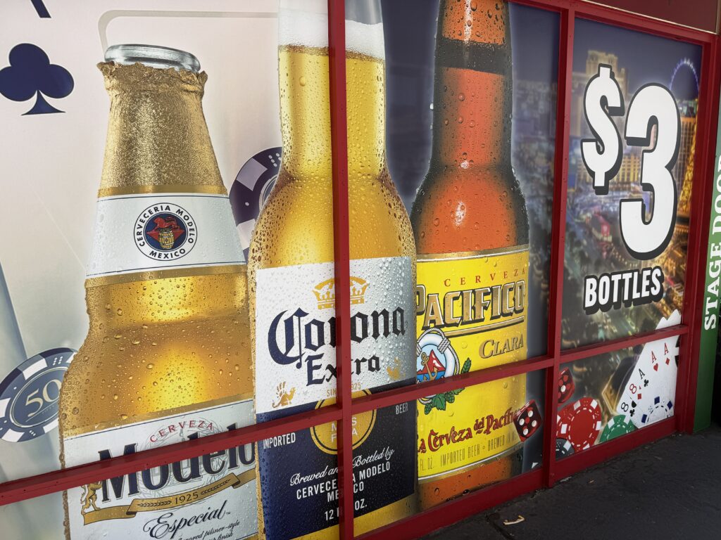 A window cling on the exterior of Stage Door Casino advertising $3 bottles.