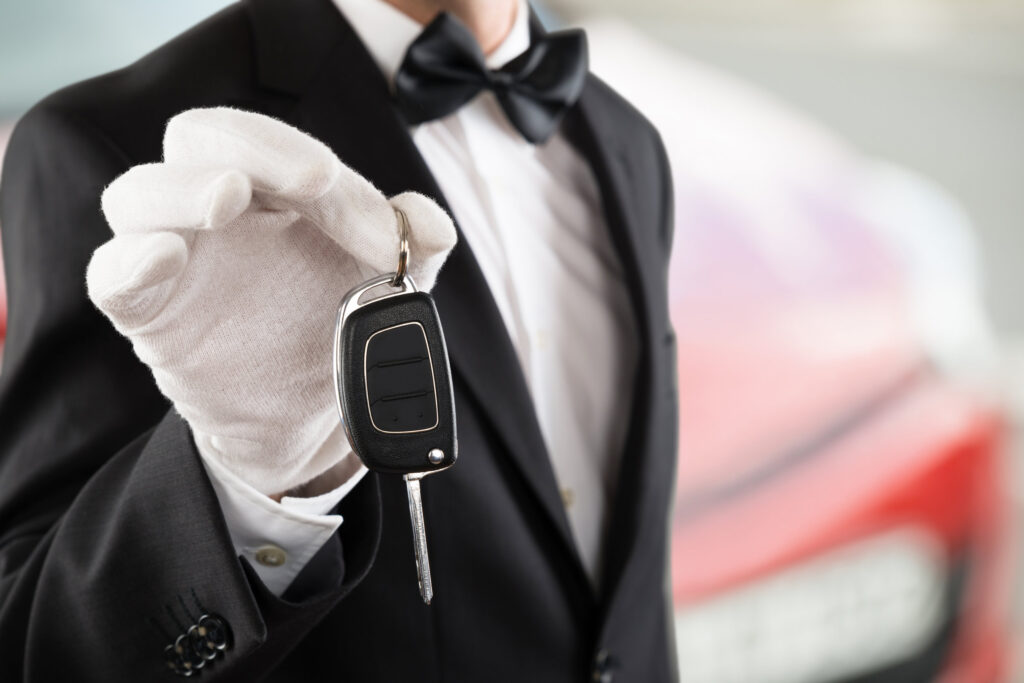 Valet employee handing over a car key