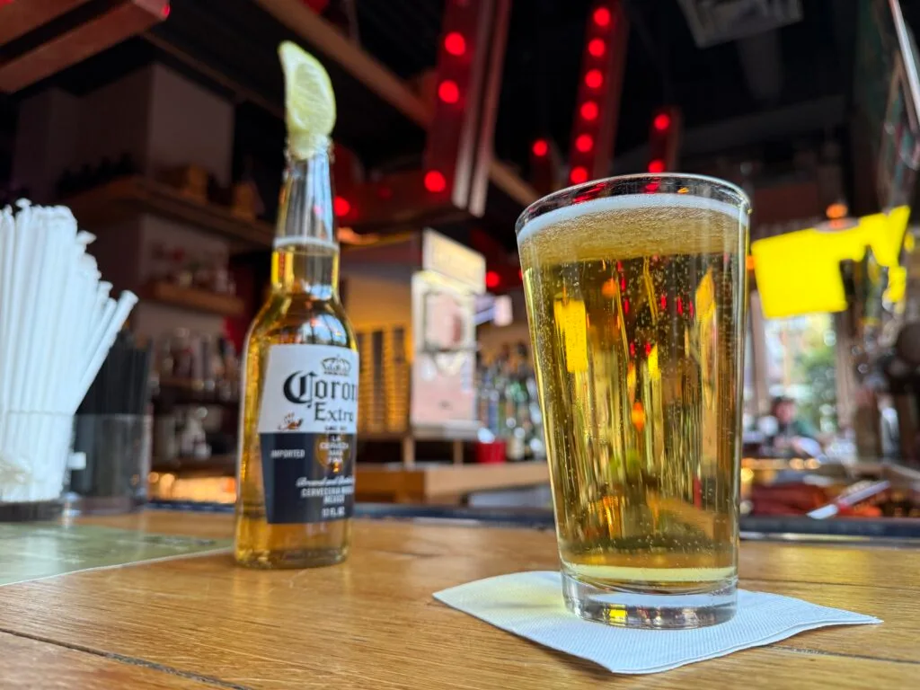 2 beers sitting on a bartop.