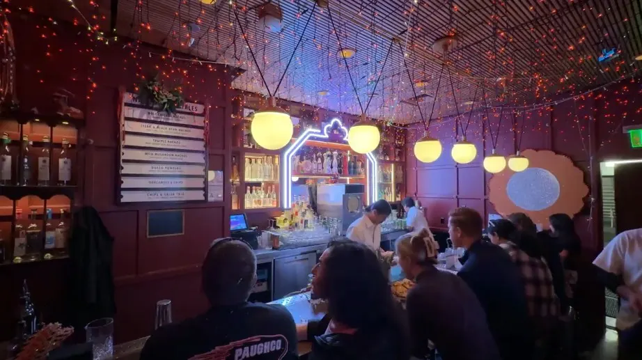 Another angle of the bar, with holiday-style lights hanging from the ceiling. 