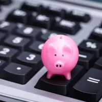 Piggy Bank sitting on a calculator