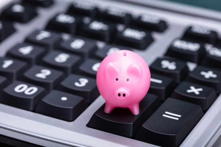 Piggy Bank sitting on a calculator