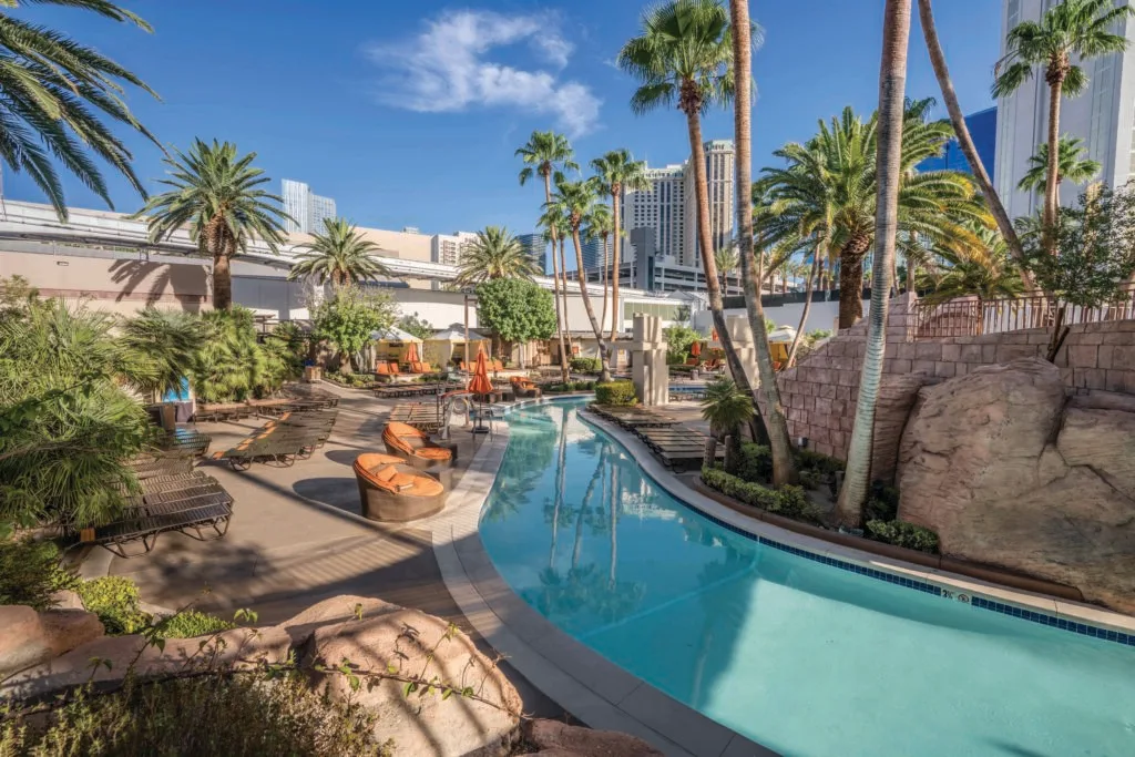 Lazy river cuts through palm trees and seating at MGM Grand.