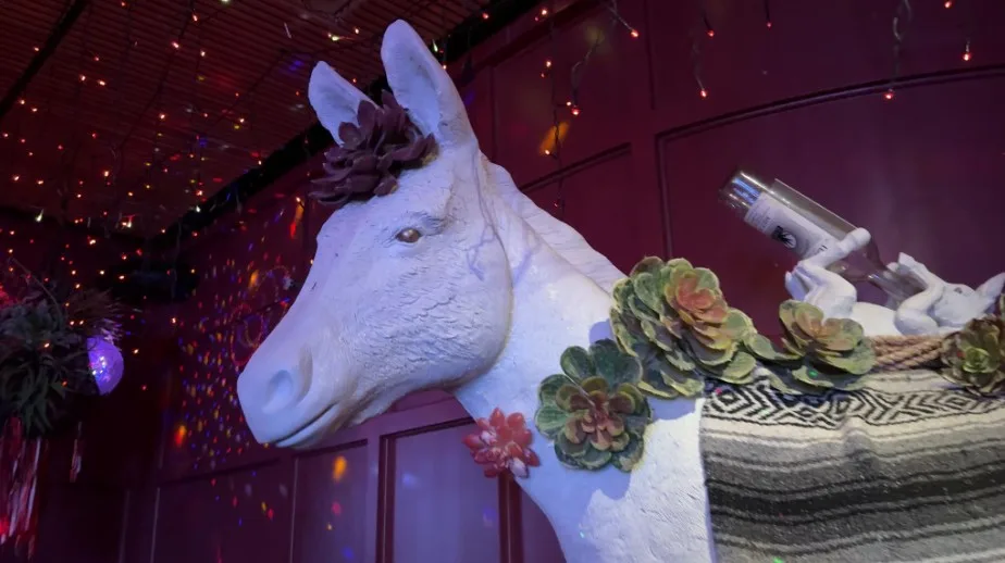 A white statue of a donkey used as decor in the bar. 