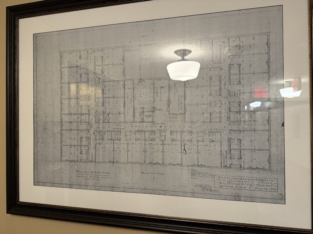 A framed blueprint, hanging as a decoration in the hallway. 