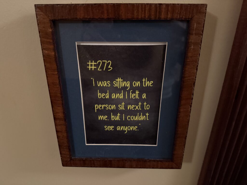 A testimonial posted outside of my room that says "I was sitting on the bed and I felt a person sit next to me, but I couldn't see anyone".