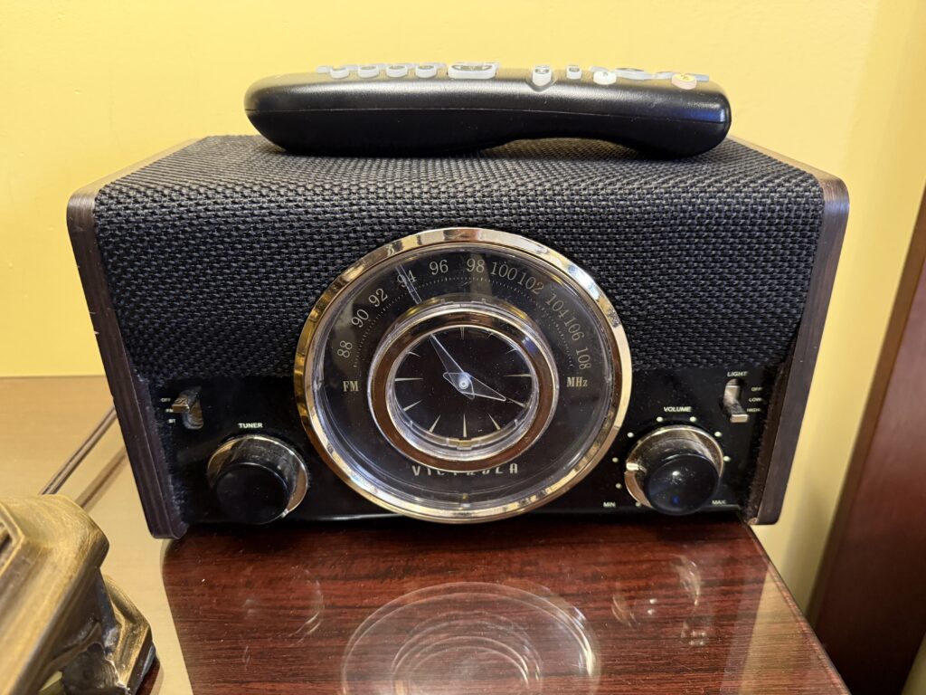 An old timey radio on the bedside nightstand. 