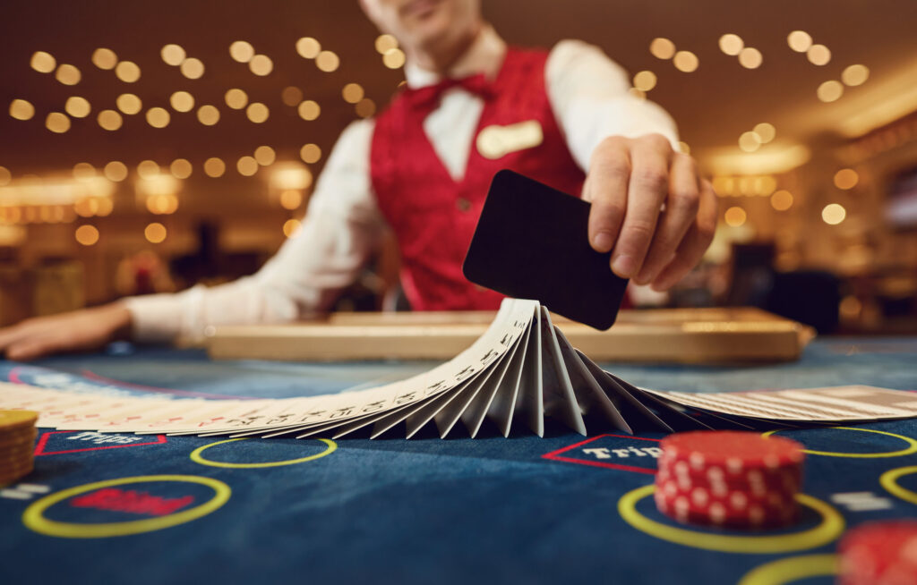 A dealer fans the playing cards on the felt table