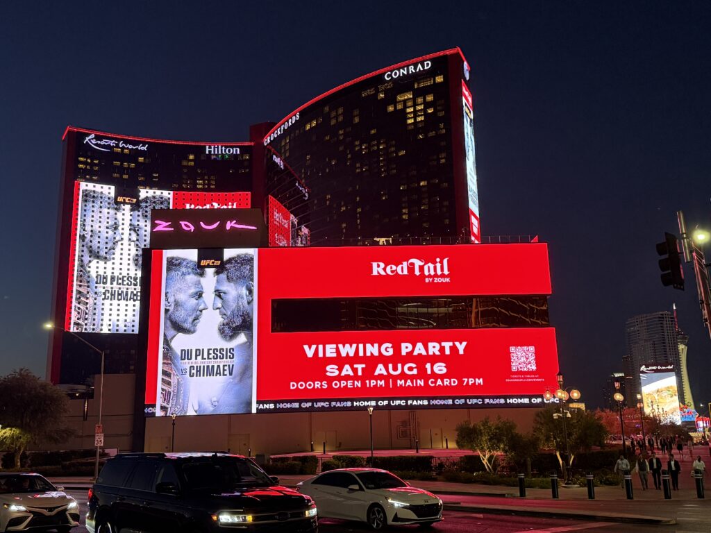 A Red Tail ad is displayed on the exterior video board at Resorts World. 
