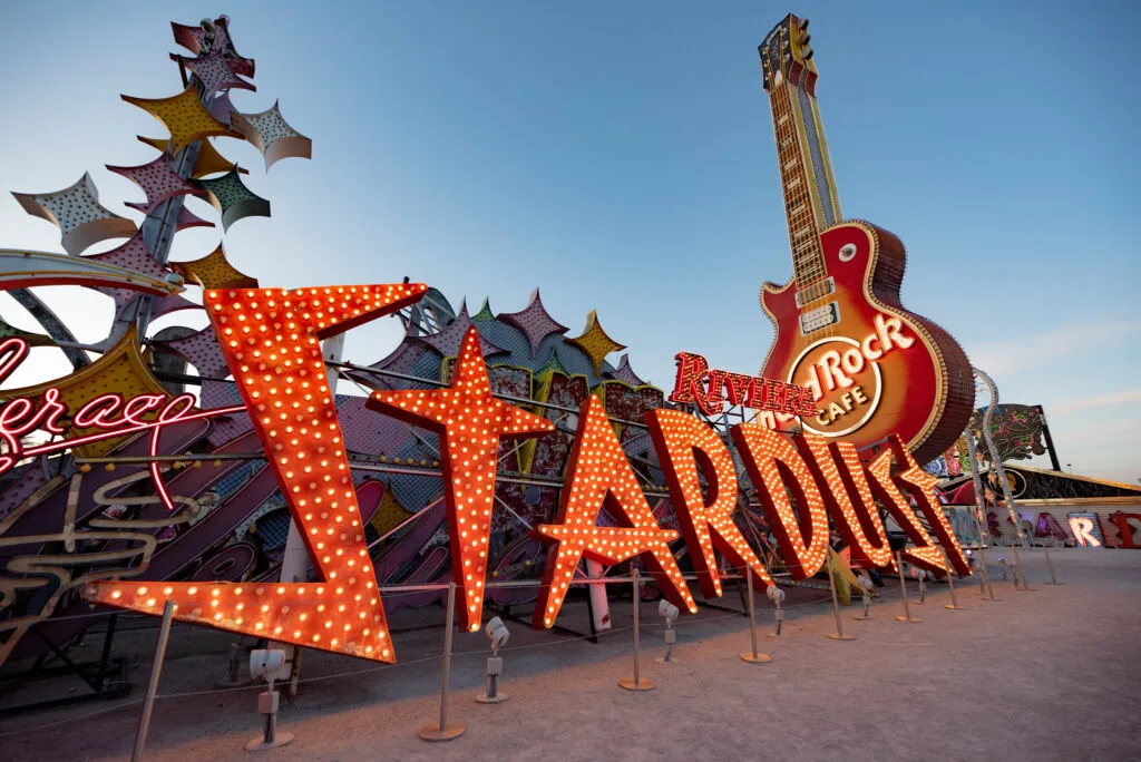 A Stardust sign using googie font is illuminated in red. 