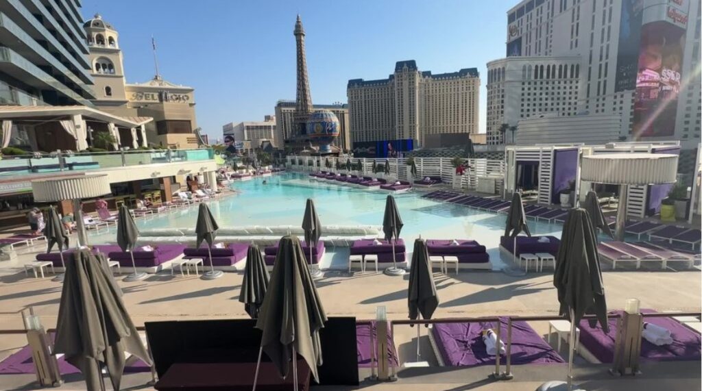 The rooftop Boulevard pool in the shape of a triangle with resorts along the Strip in the background.