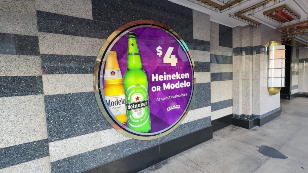 A sign advertising $4 bottles of beer at Boyd properties. 