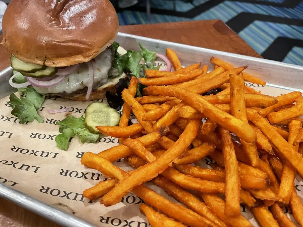 Burger at Luxor's Pyramid Cafe with Sweet Potato Fries served on a metal tray