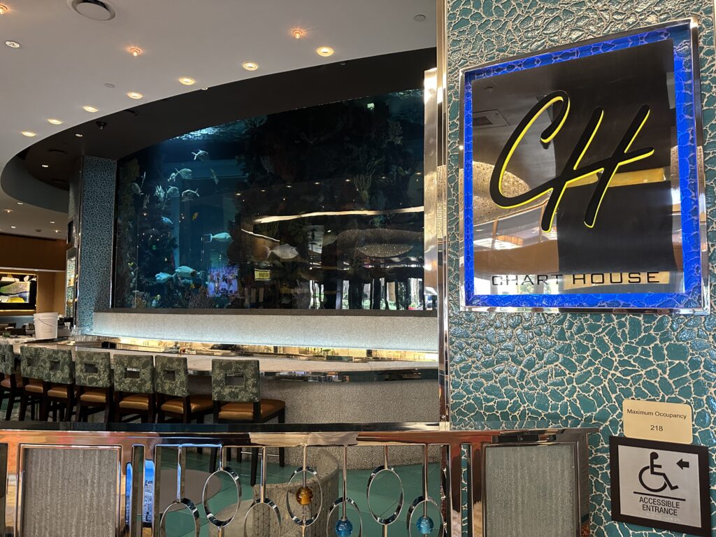 Exterior of Chart House with a view of their aquarium behind the bar.