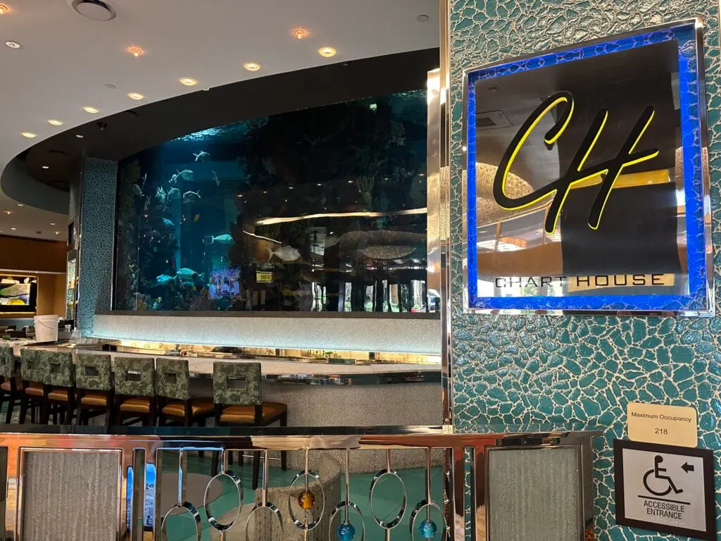 Exterior of Chart House with a view of their aquarium behind the bar.