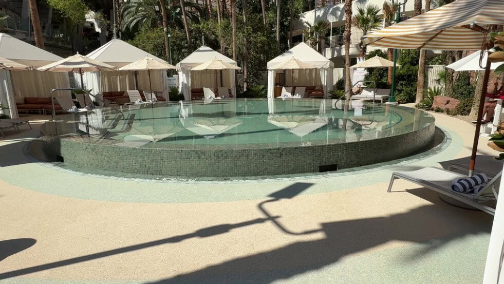 A small circular pool at Flamingo surrounded by cabanas.