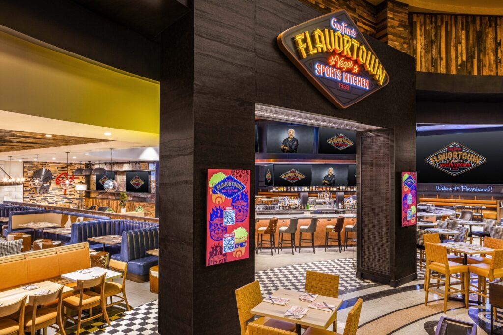 Entry and seating area for Guy Fieri's new Flavortown restaurant. Scattered throughout the venue are a large number of televisions.