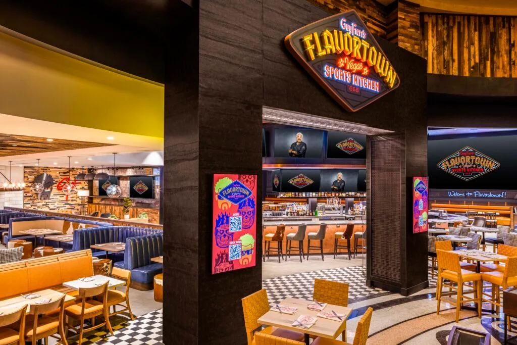 Entry and seating area for Guy Fieri's new Flavortown restaurant. Scattered throughout the venue are a large number of televisions.