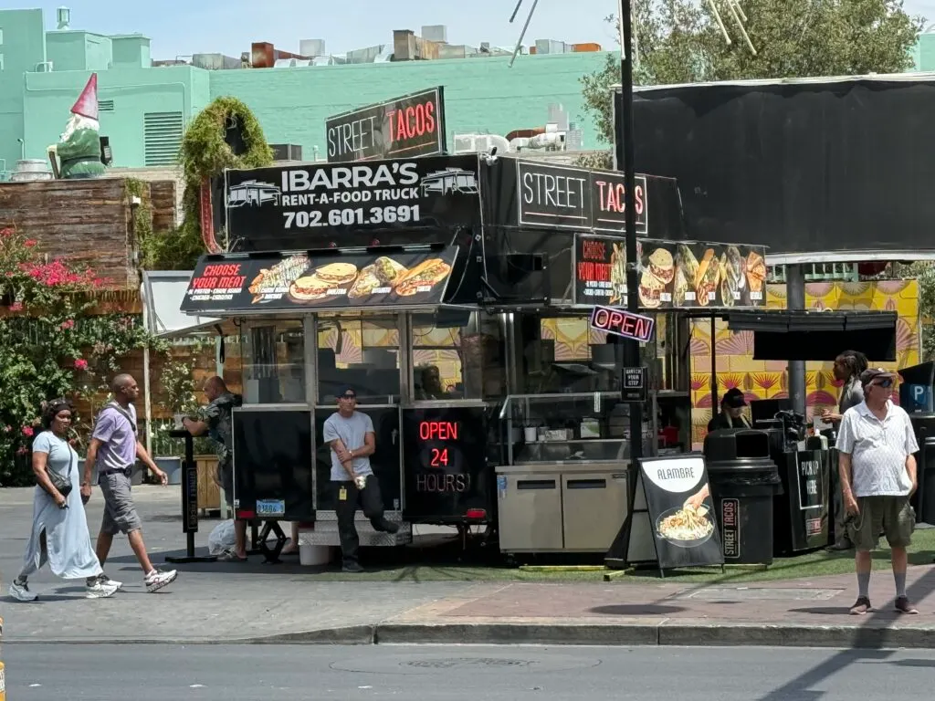 A taco truck on the corner of Fremont Street. 