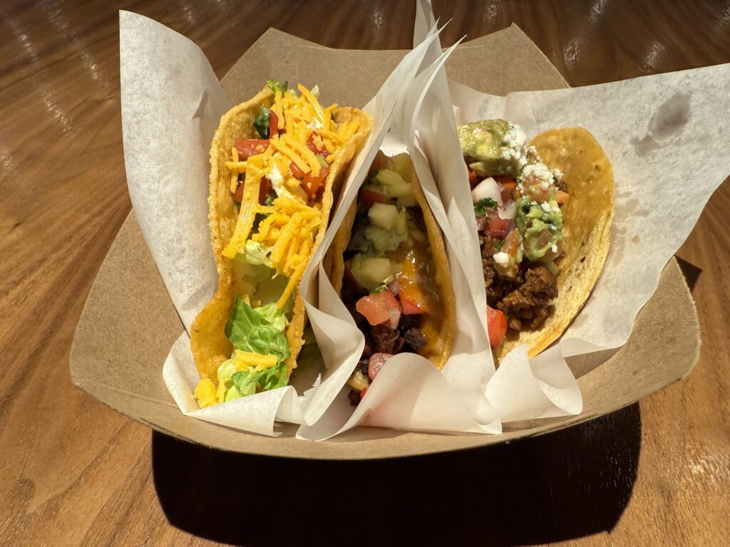 3 planet based tacos in a tray.