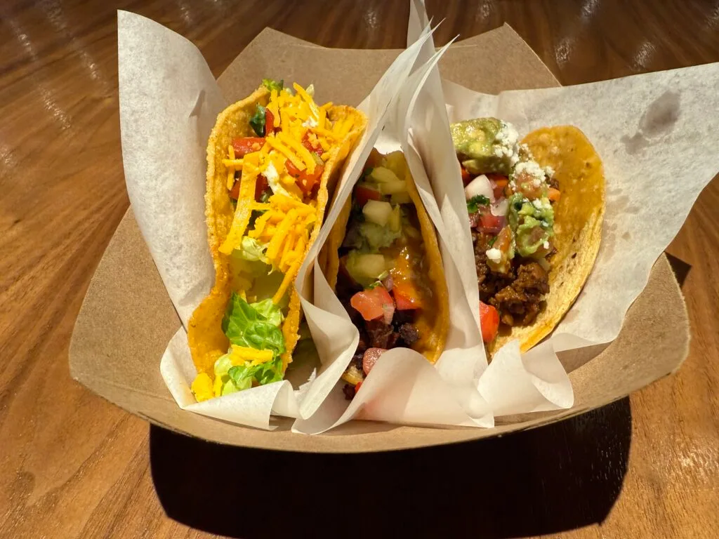 3 planet based tacos in a tray. 