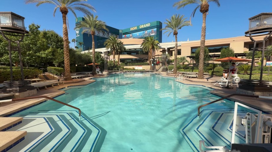 A large pool, with MGM Grand's hotel tower looming in the background.