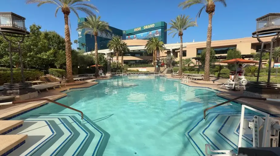 A large pool, with MGM Grand's hotel tower looming in the background.