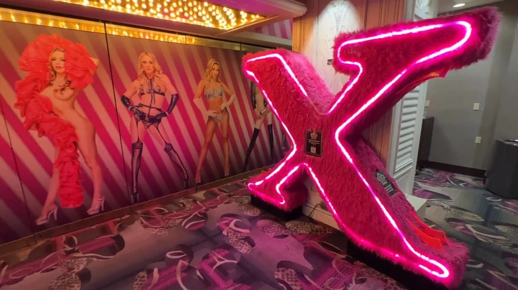 A big furry X next to a picture of several burlesque performers. 