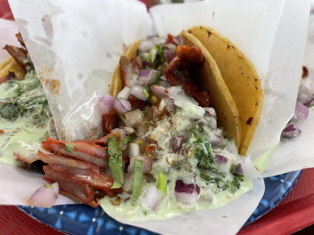 Adobada taco from Tacos El Gordo with meat, pico, and avacado sauce dumped on top