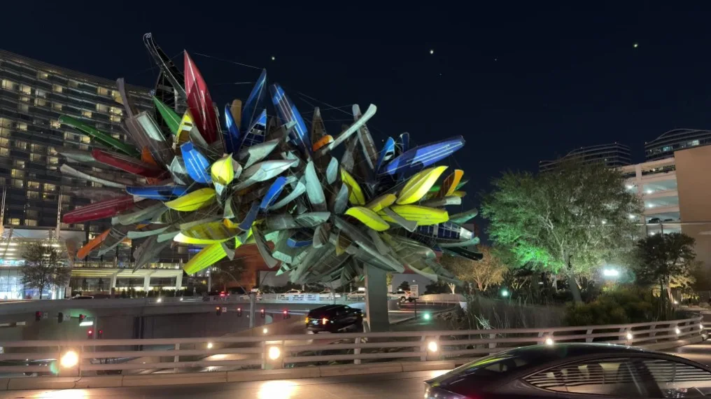 A sculpture made out of canoes in front of Aria.