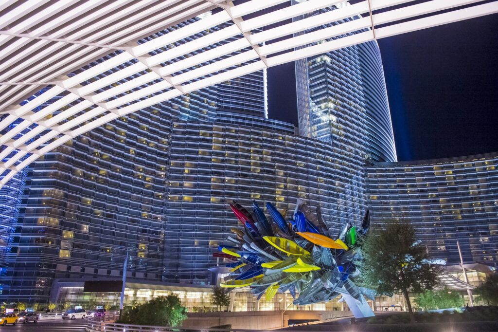 A sculpture of boats sitting in front of Aria's hotel tower.