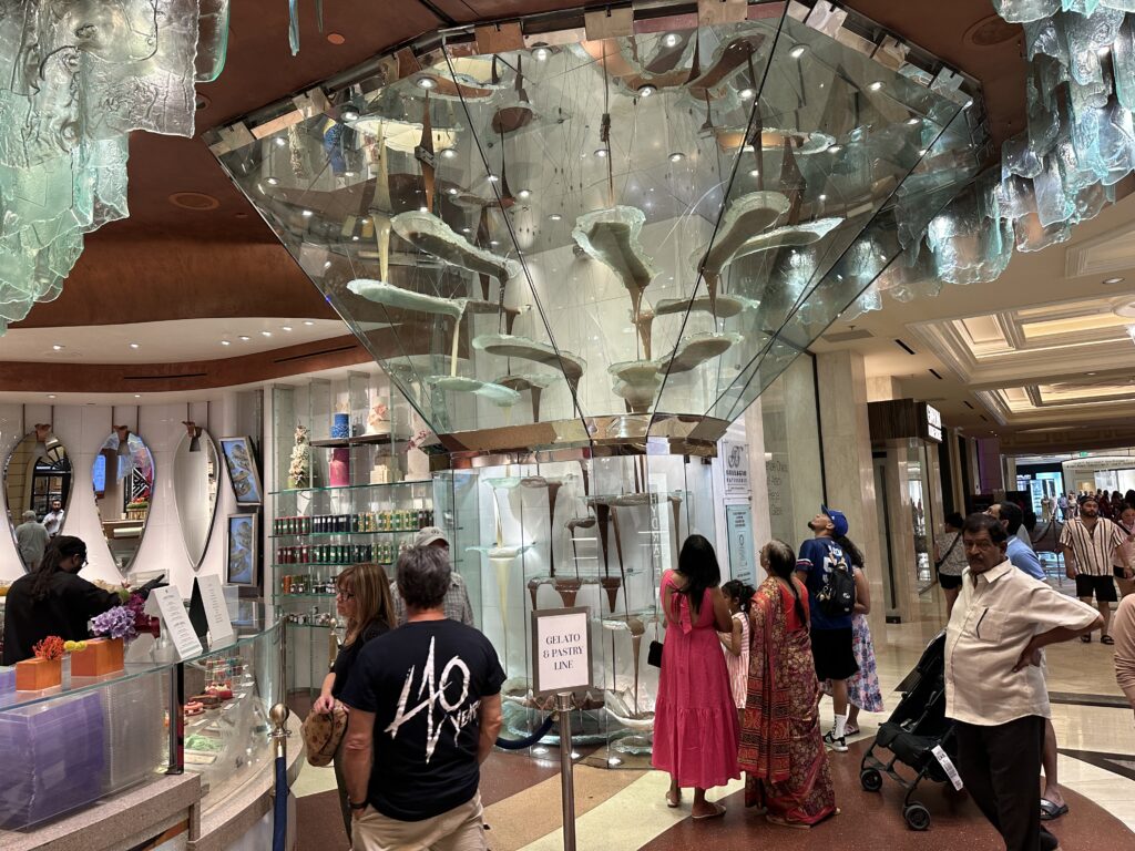 A glass chocolate fountain in the bakery.